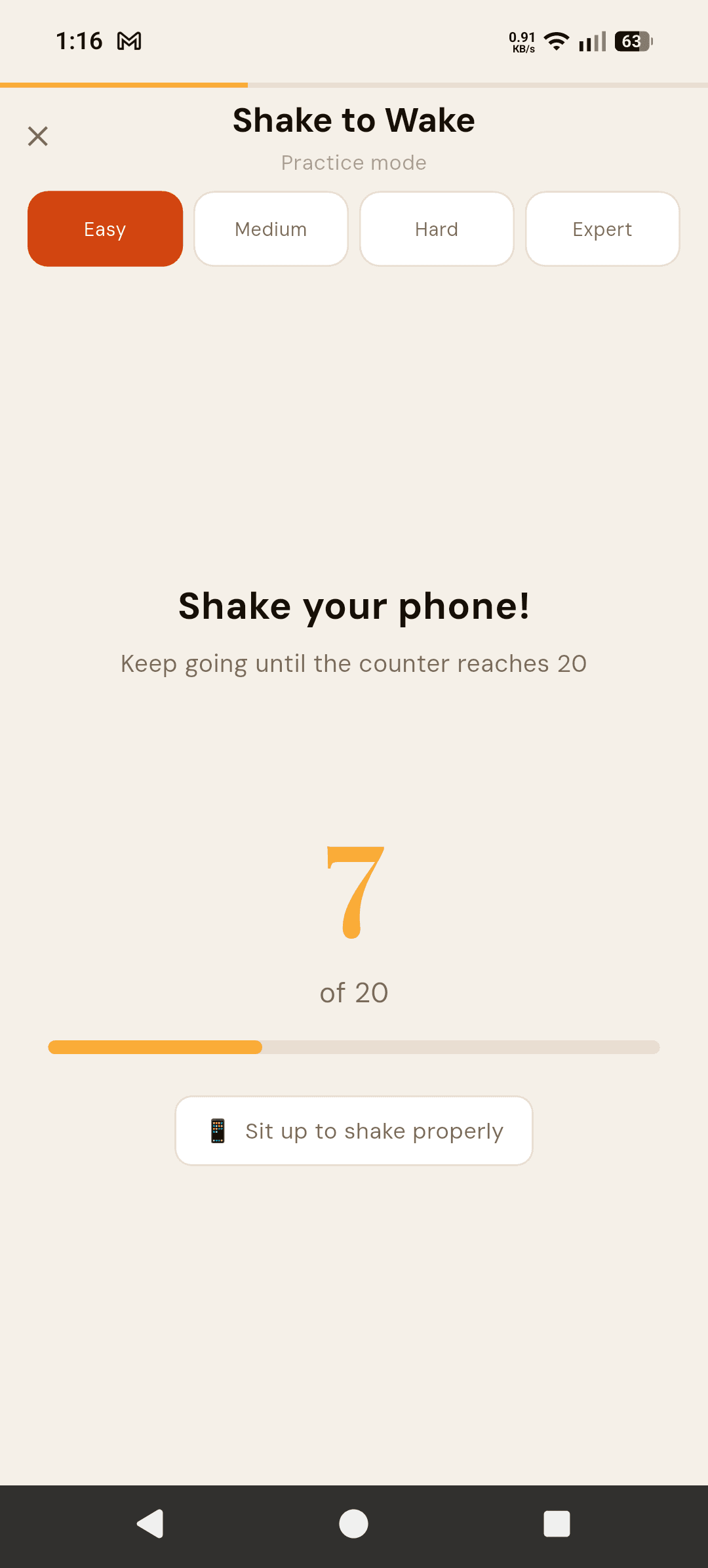 Alarmor Shake to Wake mission on Easy: "Shake your phone! Keep going until the counter reaches 20", counter at 7 of 20, with the hint "Sit up to shake properly"